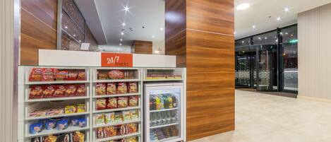 A snack vending machine with a variety of snacks and drinks.