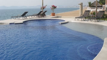 Outdoor pool, an infinity pool, sun loungers