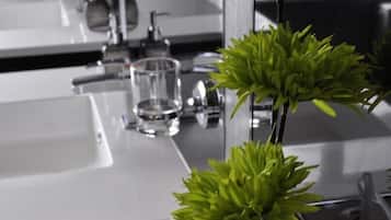 A modern bathroom with multiple sinks and a mirror.