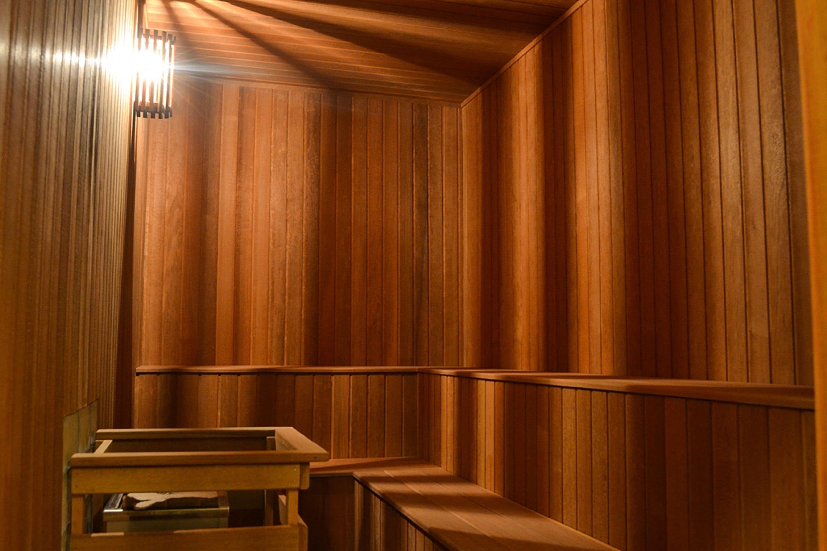Una habitación con paneles de madera, un banco y una mesa.