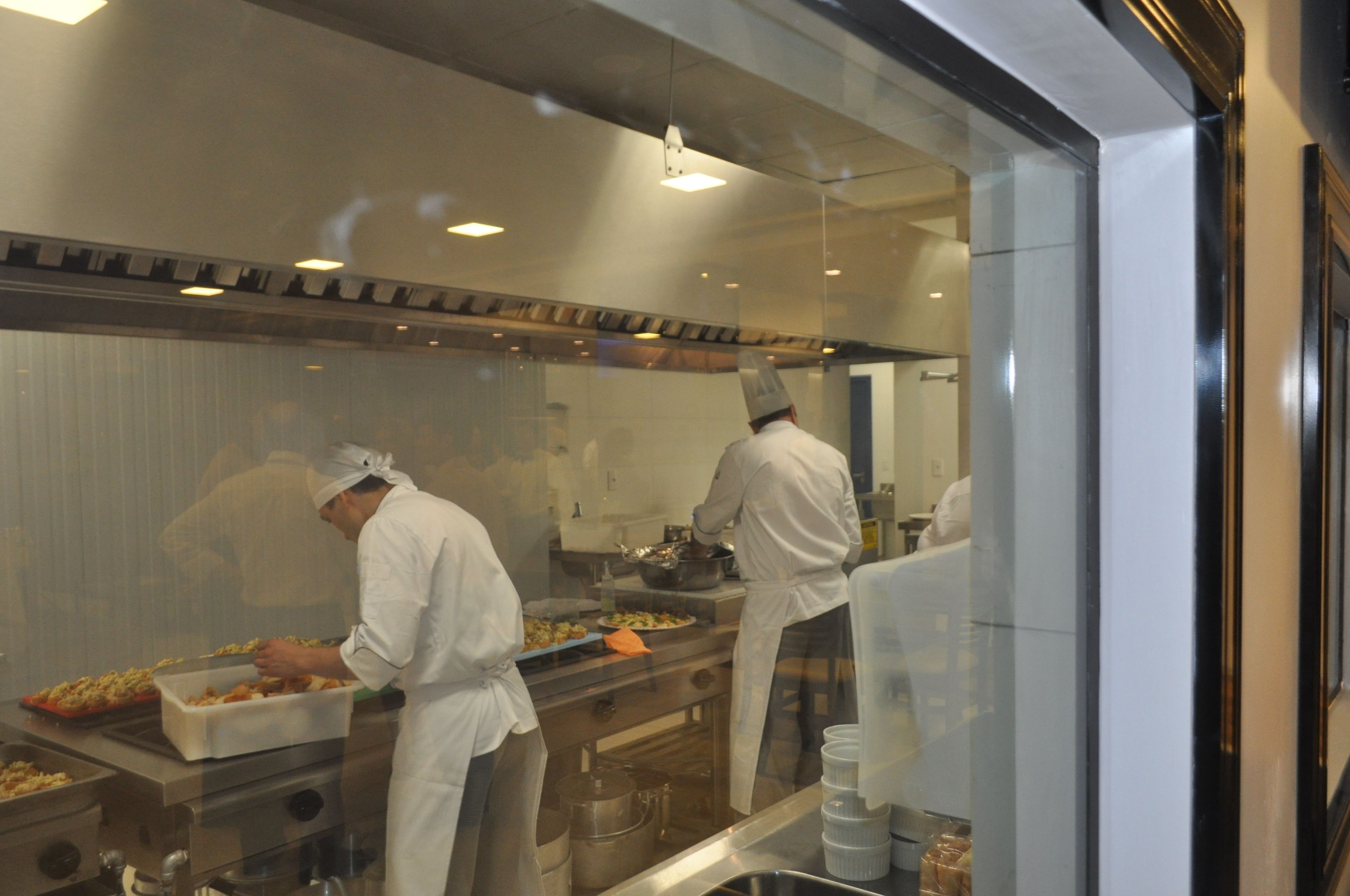A professional kitchen with chefs preparing food.