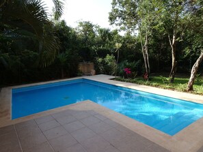 A rectangular swimming pool with a tiled deck area. - La Salamandra (Puerto Aventuras)