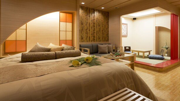 A modern hotel room with a large bed, a seating area, and a small dining table. - Hotel Watergate Okayama - Adults Only (Okayama)