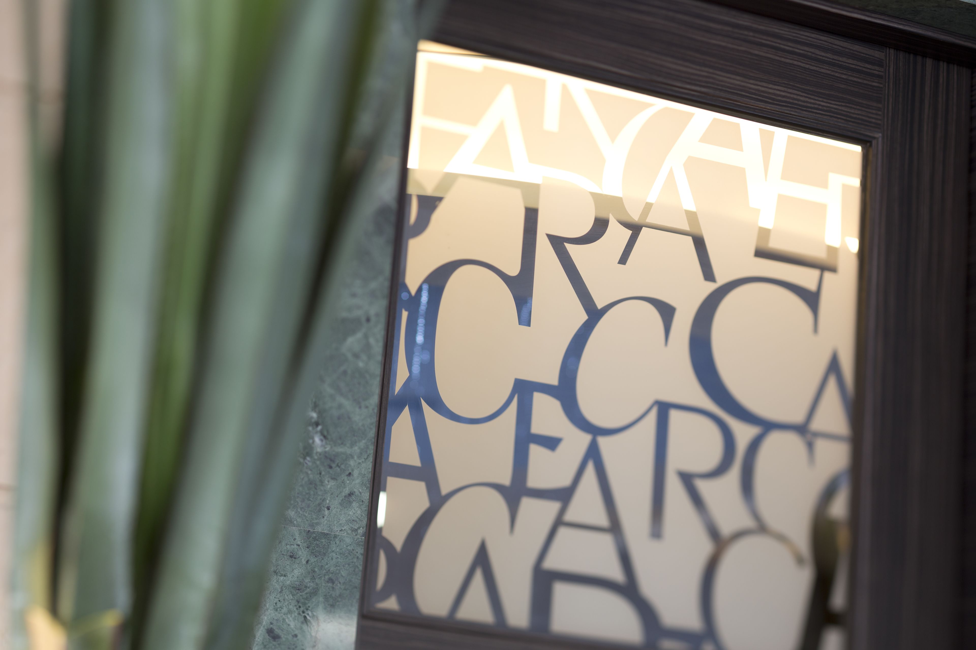 A close-up of a window with geometric patterns and the word "FAYAH" partially visible.