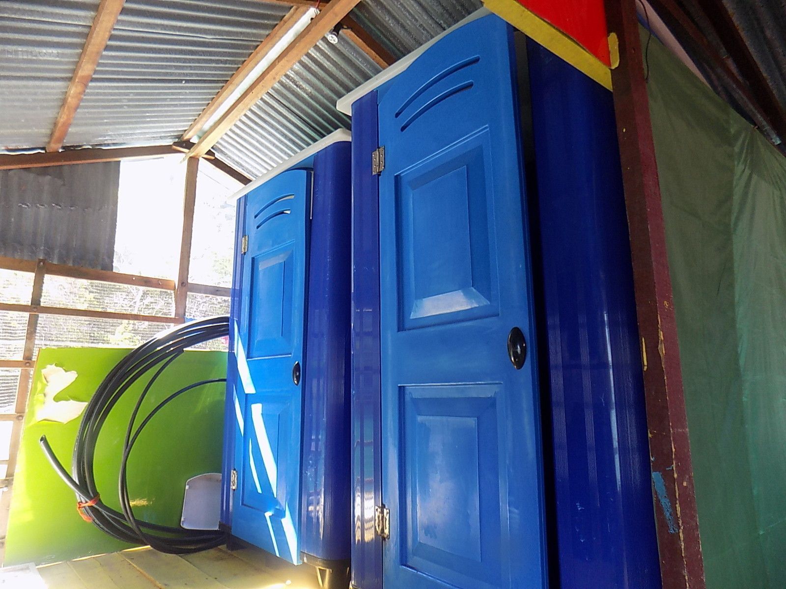 A row of blue lockers with a green and red door frame.