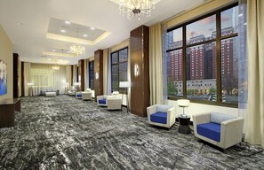 A hotel lobby with multiple seating areas, large windows with city views, and modern lighting fixtures. - Embassy Suites By Hilton Pittsburgh Downtown (Pittsburgh)