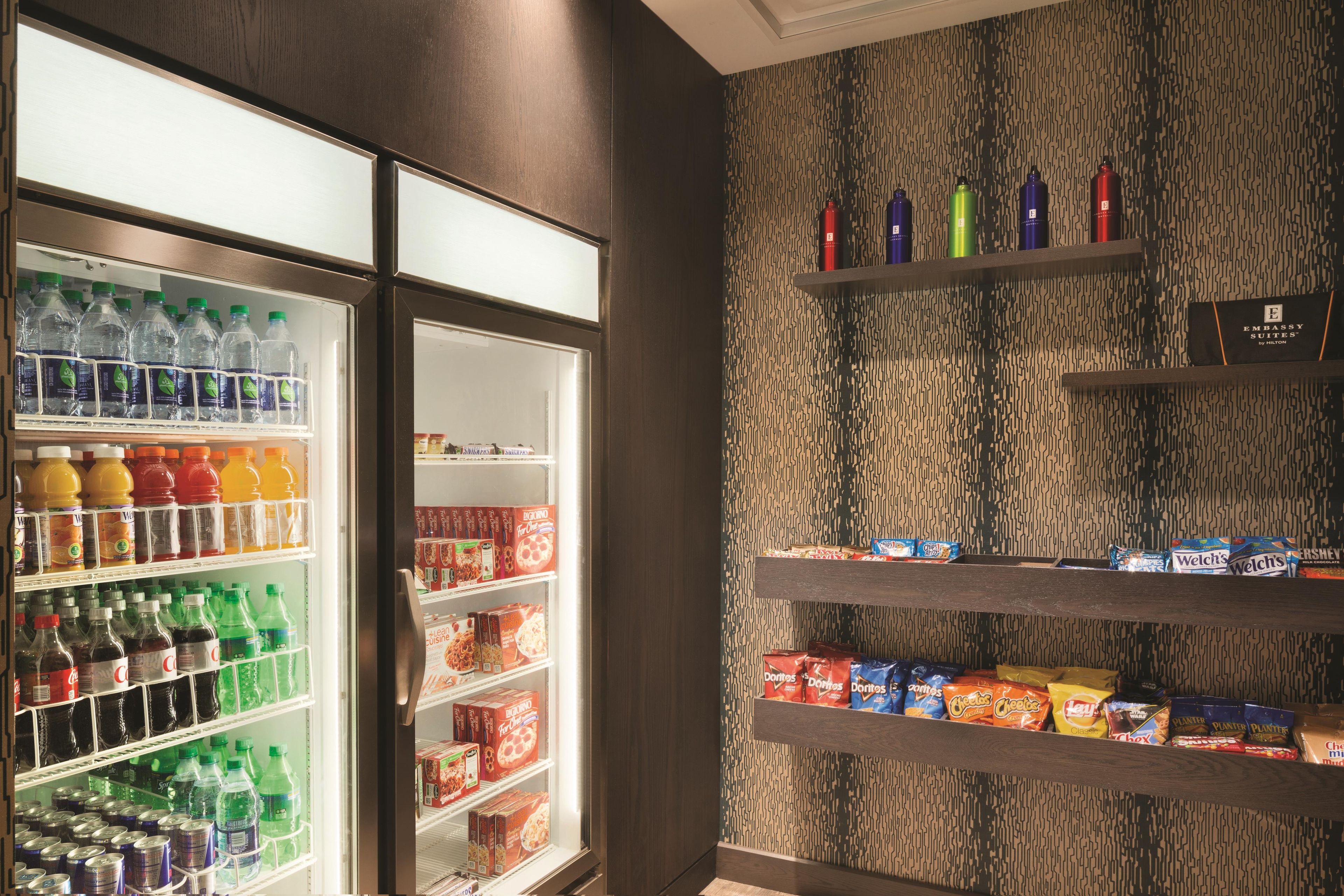 A hotel minibar with various beverages and snacks.