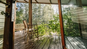 A wooden deck with a bench and a view of a forest. - The Farmhouse at Polo Escape (Sattahip)