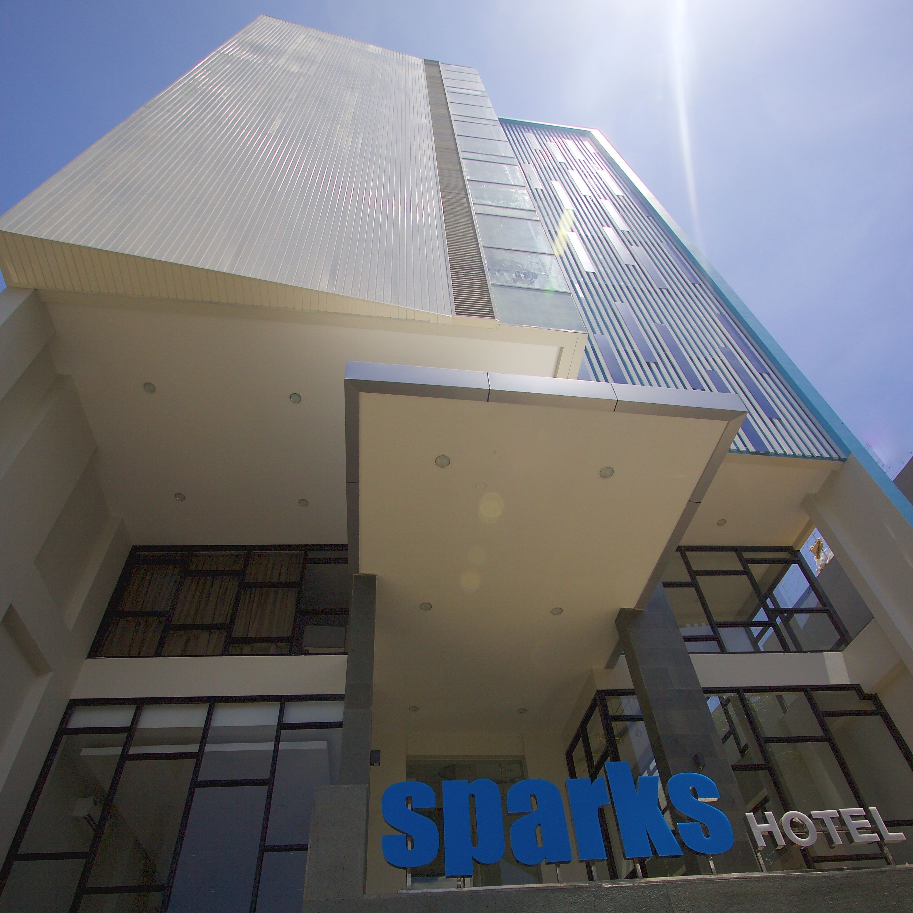 A hotel with a modern design, featuring a prominent 'Sparks Hotel' sign.