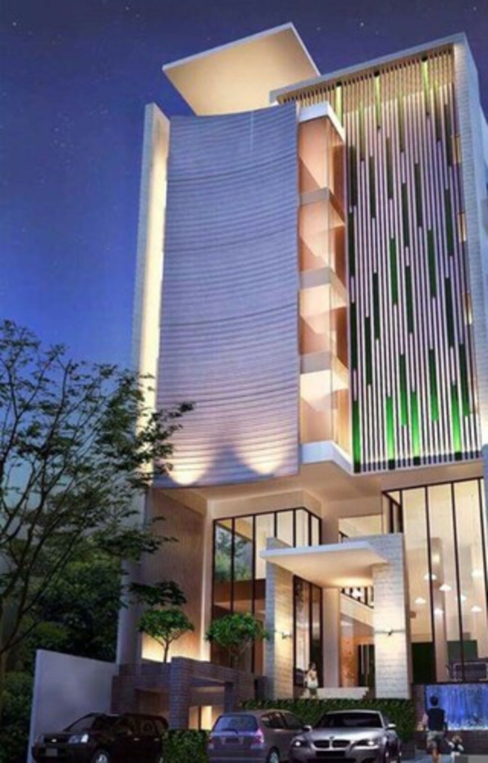 A modern building with a unique architectural design, featuring a combination of vertical and horizontal elements, large windows, and a well-lit entrance.