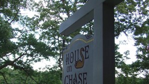 A sign for 'House on Chase Creek' with a duck illustration. - House on Chase Creek (Shelter Island Heights)