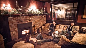 A cozy living room with a fireplace, comfortable seating, and a warm ambiance.