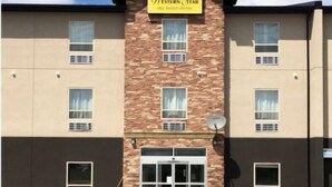 A Western Star hotel with a brick facade, multiple windows, and a central entrance. - Western Star All Suites Melita (Melita)