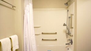 A standard hotel bathroom with a bathtub, shower, and handrails. - Holiday Inn Express & Suites Omaha - Millard Area by IHG (Omaha)