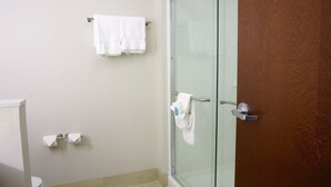 A bathroom with a toilet, a glass shower enclosure, and a towel rack with two white towels. - Holiday Inn Express & Suites Omaha - Millard Area by IHG (Omaha)