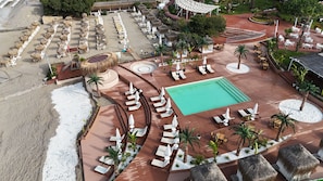 An aerial view of a resort with a swimming pool, sun loungers, and thatched umbrellas. - Club Aqua Plaza (Alanya)