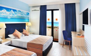 A hotel room with a bed, a desk, and a chair. There is a painting of a sailboat on the wall, and a window with curtains. - Club Aqua Plaza (Alanya)