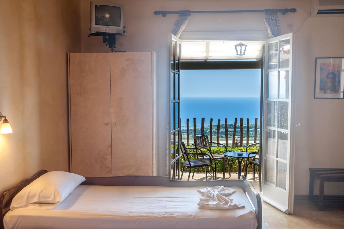 desk, laptop workspace, iron/ironing board, bed sheets