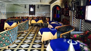 A restaurant with patterned walls, checkered flooring, and traditional decor. - Hotel Al Mamoun (Casablanca)