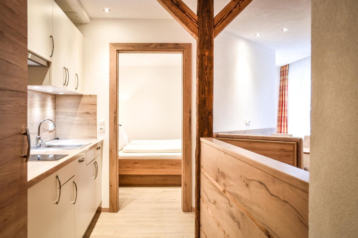A modern kitchen with wooden accents, a built-in oven, and a sink.