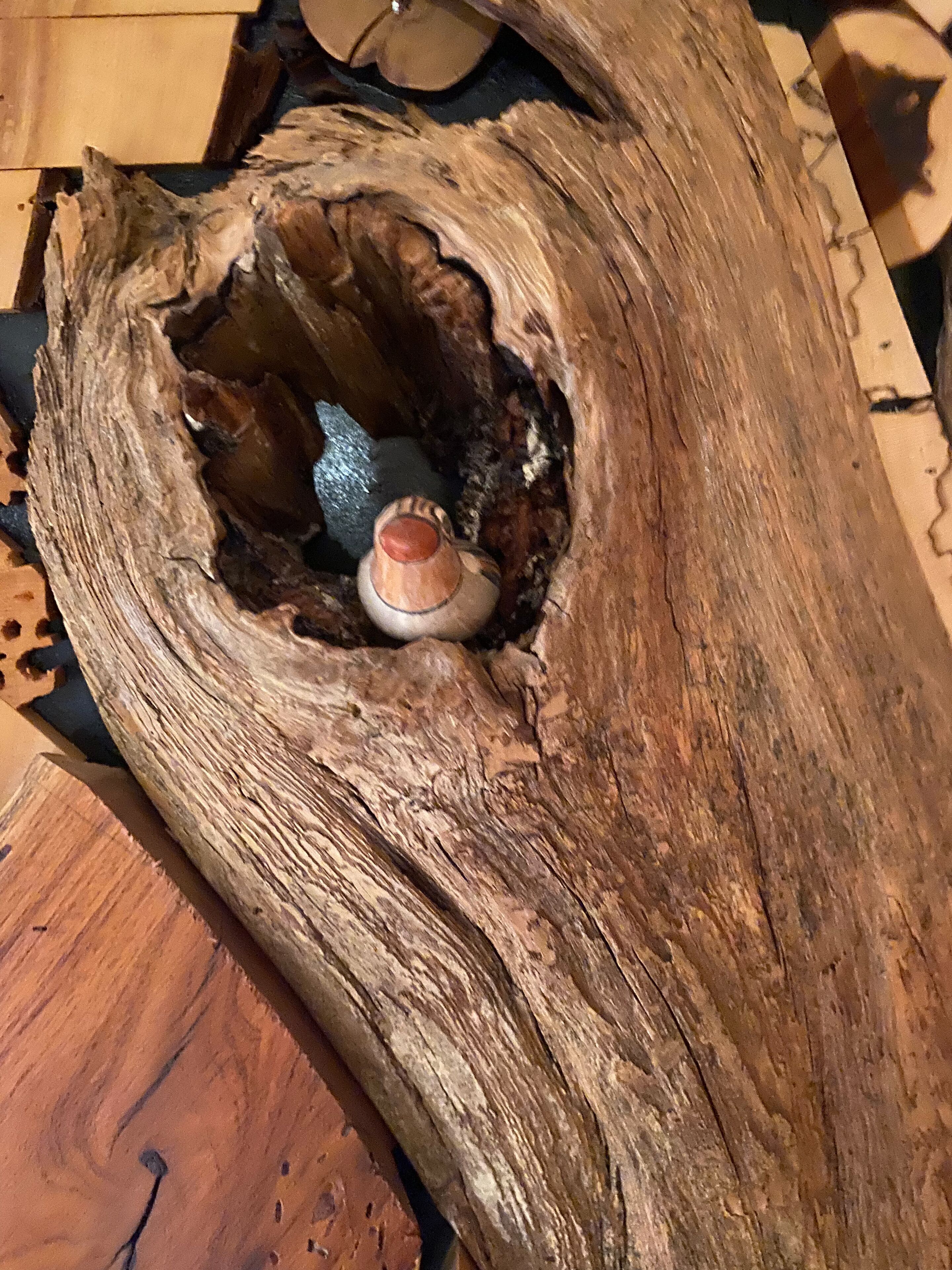 A wooden sculpture with a hollow center, possibly a decorative piece.