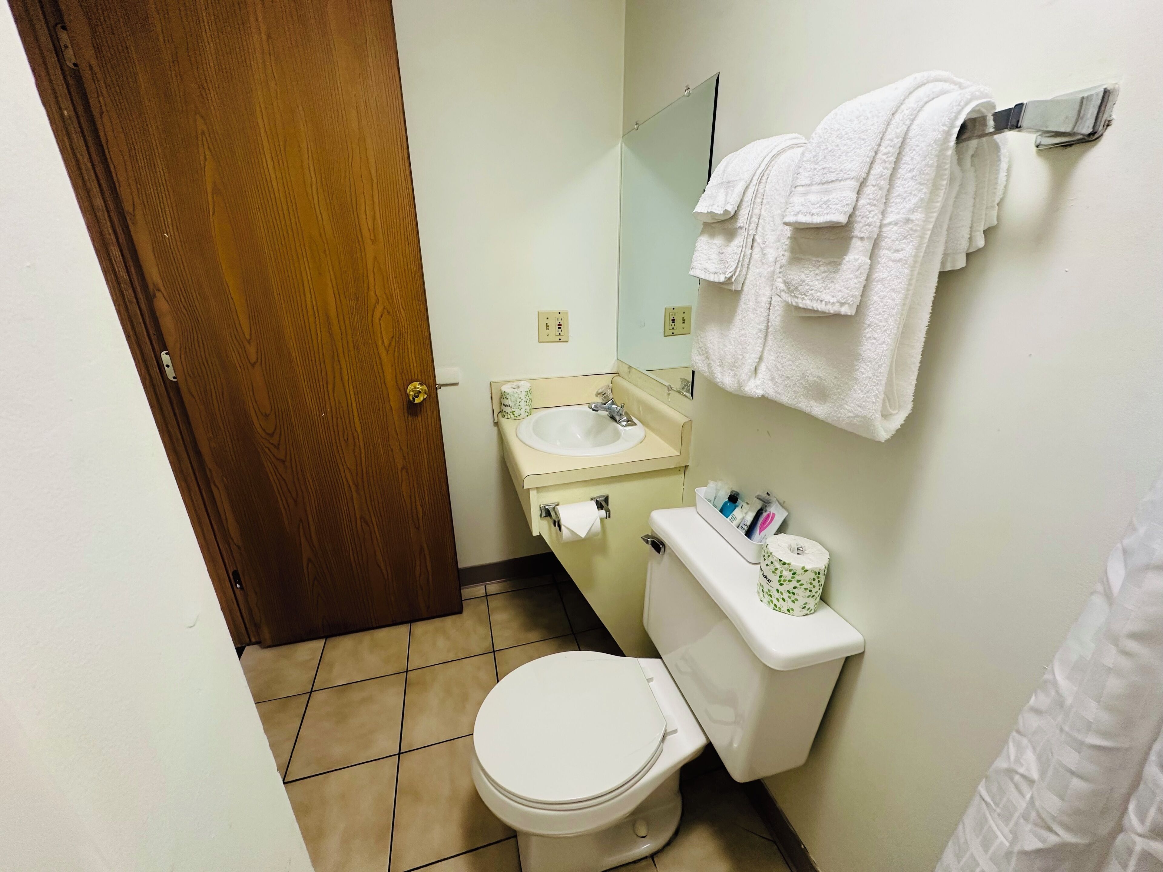 Ein kleines Badezimmer mit Toilette, Waschbecken und Handtuchhalter.