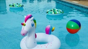 A pool with inflatable toys including a unicorn and a beach ball. - Quality Lodge (Sandusky)