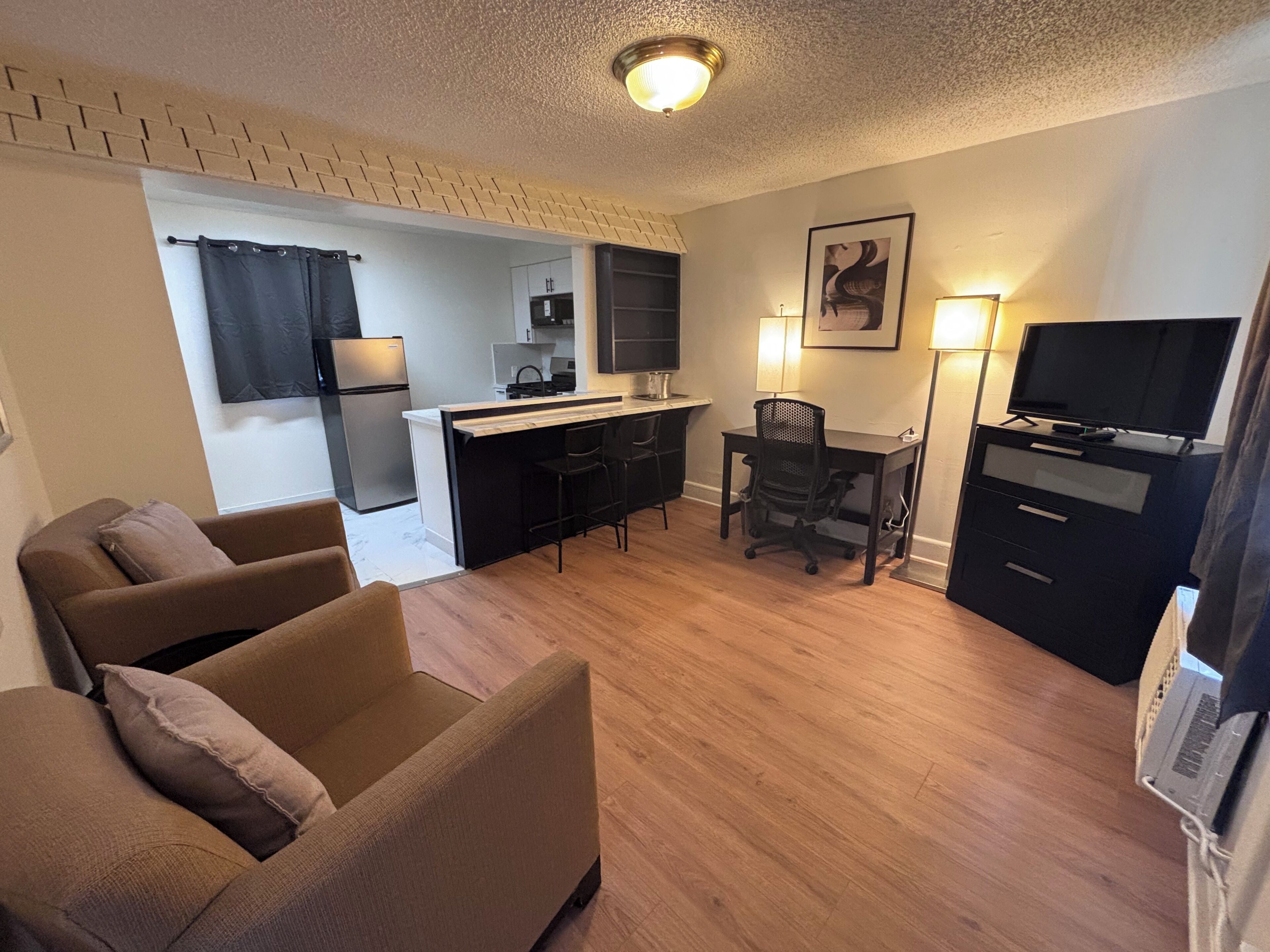 Deluxe Suite, 1 Bedroom | Living area | 36-inch LED TV with cable channels, TV
