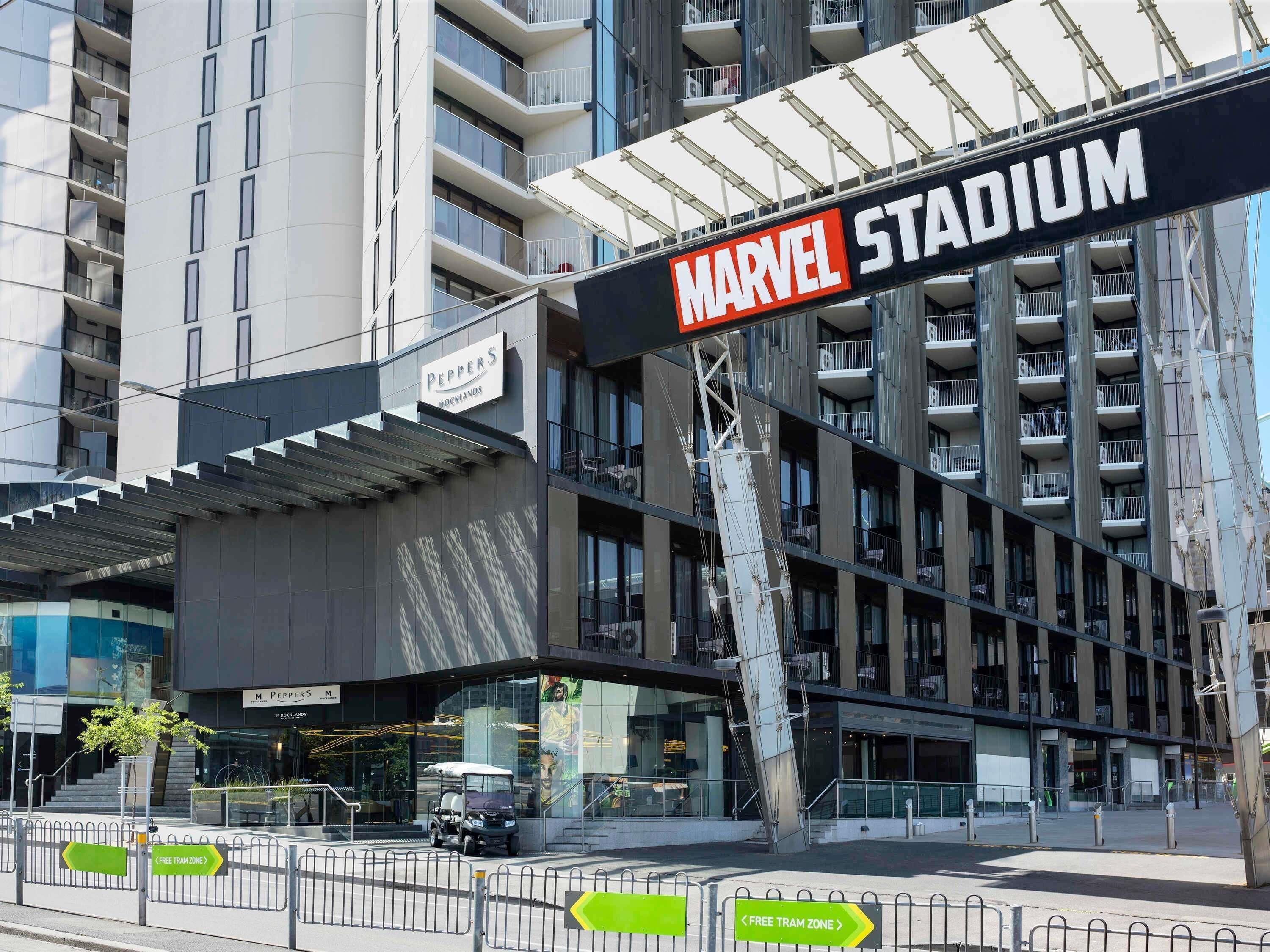 A modern building with a sign for 'Marvel Stadium' and a 'Peppers' sign above the entrance.