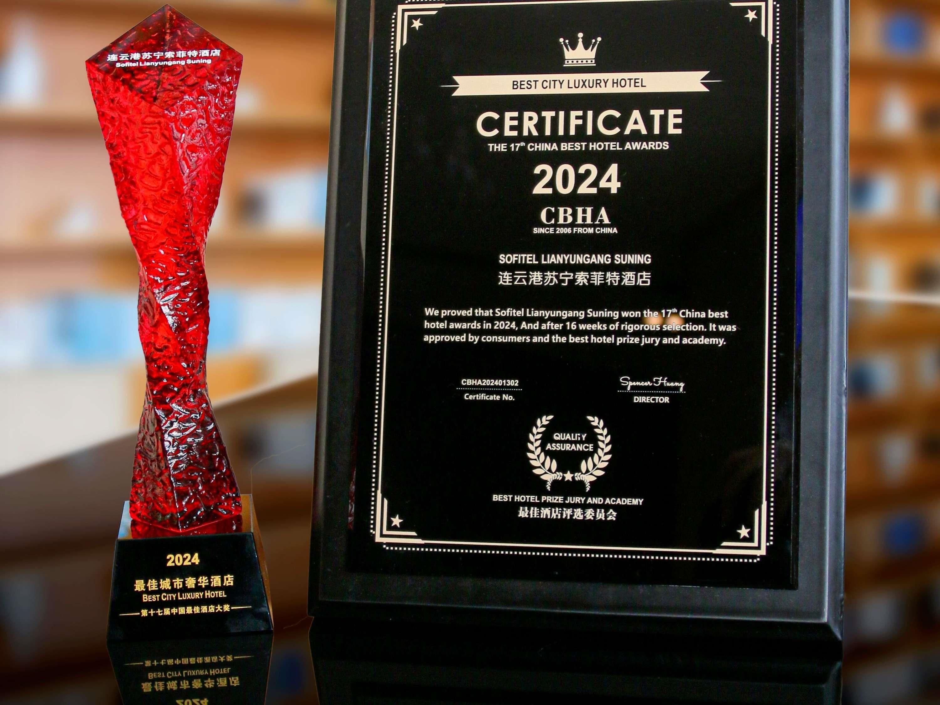 A trophy and a certificate for the 2024 CBHA Best City Luxury Hotel Award.