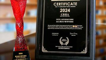 A trophy and a certificate for the 2024 CBHA Best City Luxury Hotel Award.