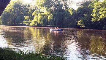 A calm river with a boat carrying people.