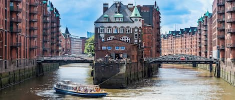 A canal with a boat and buildings on either side.