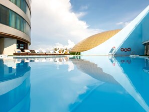 Outdoor pool, pool loungers, lifeguards on site