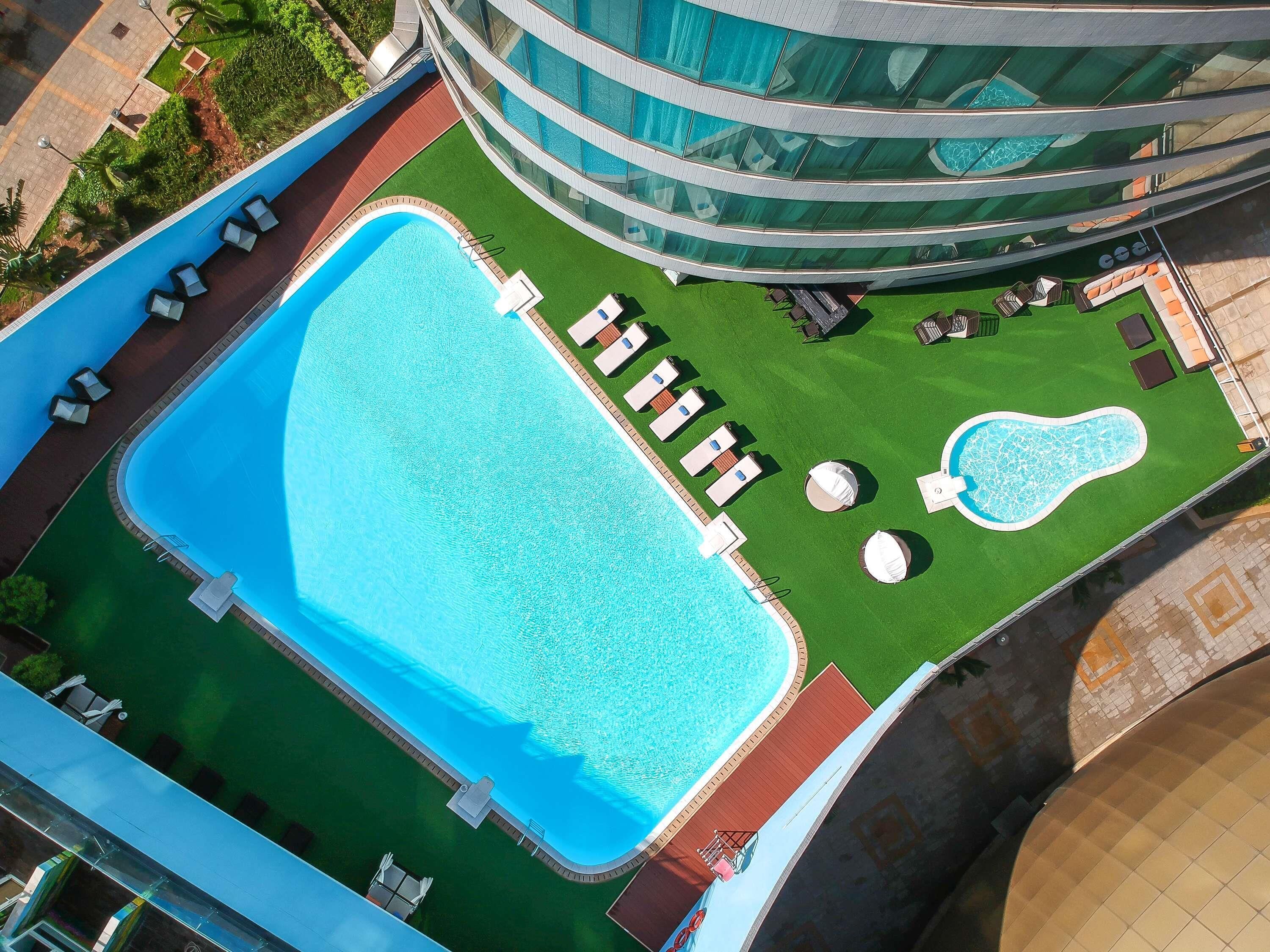 Outdoor pool, pool loungers, lifeguards on site