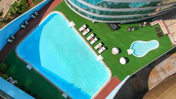 Outdoor pool, pool loungers, lifeguards on site