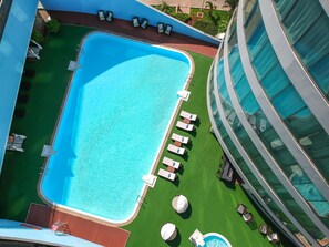 Outdoor pool, pool loungers, lifeguards on site