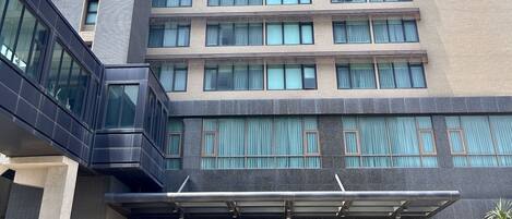 A multi-story hotel with a modern facade, large windows, and a prominent entrance labeled "GOLDEN TULIP."