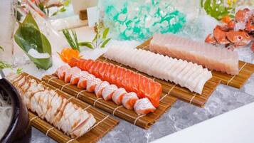 A variety of sushi on wooden trays with ice, surrounded by decorative elements.