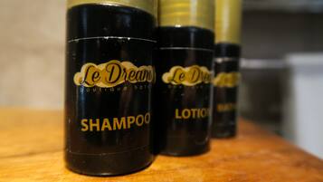 Three bottles of Le Dream boutique hotel shampoo and lotion.