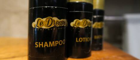 Three bottles of Le Dream boutique hotel shampoo and lotion.