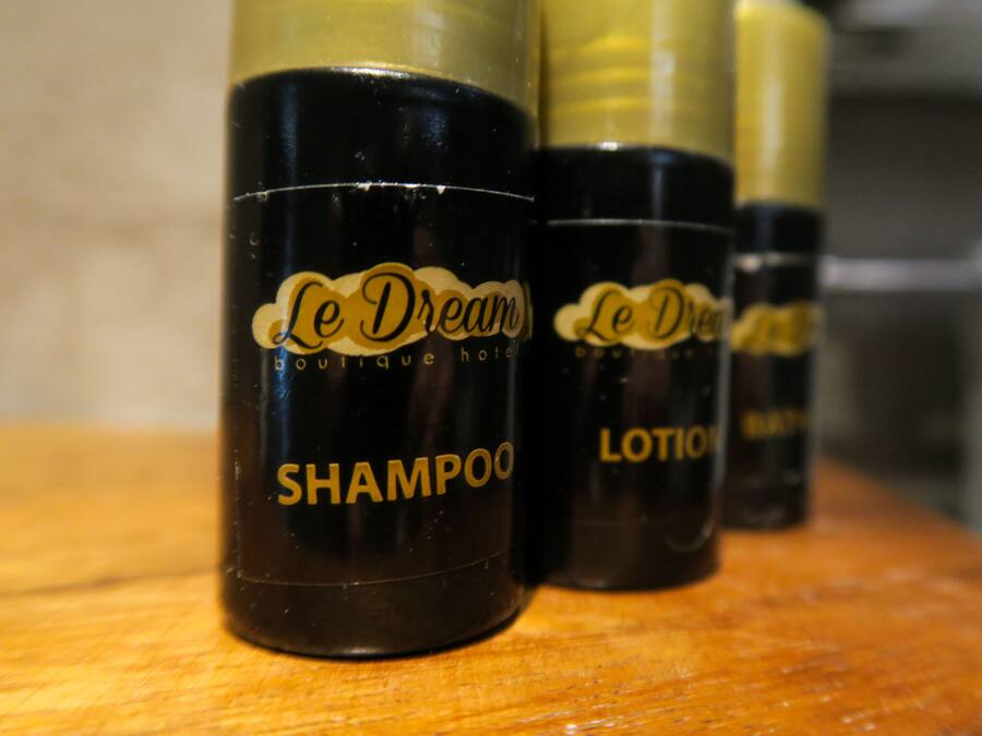 Three bottles of Le Dream boutique hotel shampoo and lotion.