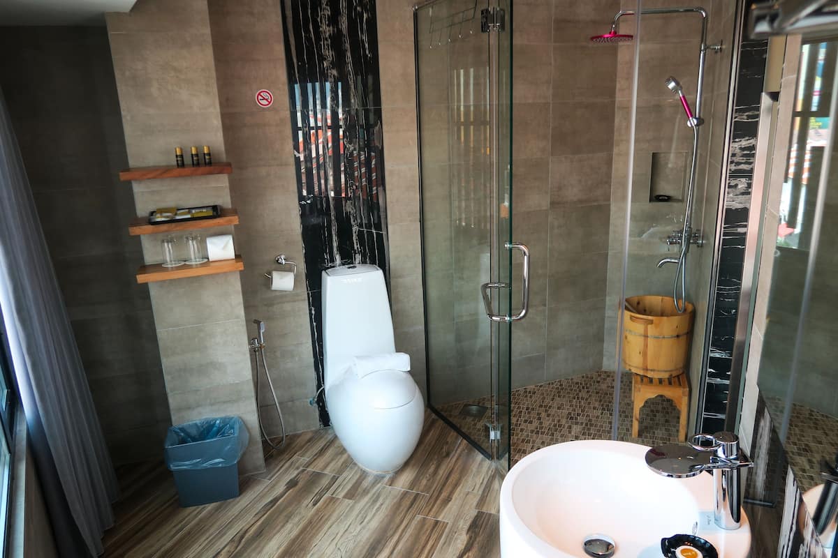 deluxe room, 1 king bed | bathroom | shower, free toiletries, bathrobes, slippers