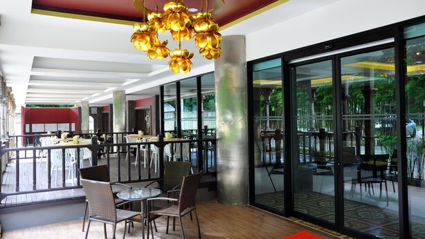 A modern interior with a glass partition, wicker chairs, and a unique golden chandelier. - Chiangmai SP Hotel (Chiang Mai)