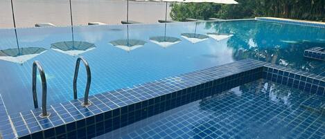Outdoor pool, open 8:00 AM to 7:00 PM, sun loungers