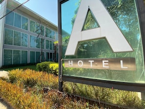 Welcome to Hotel A, a modern building with a glass facade and large windows.