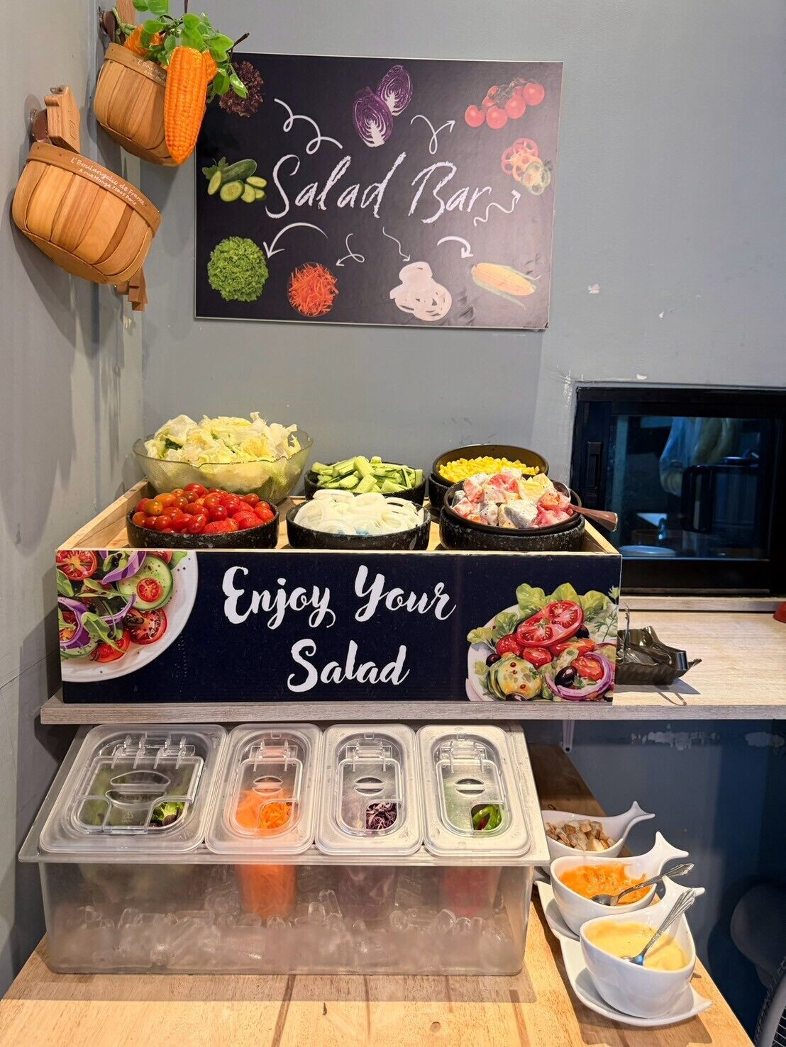 A salad bar with various fresh vegetables and salad options.