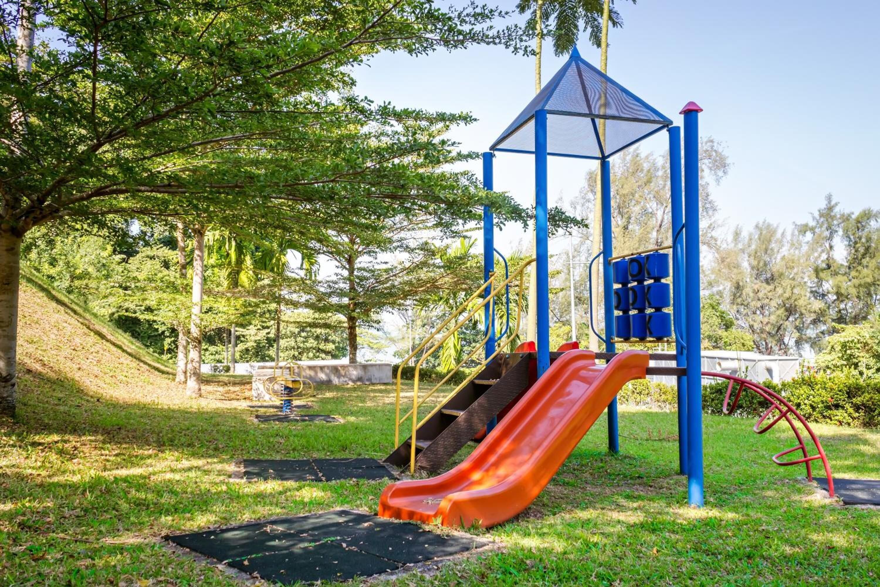 A playground with a slide and climbing structures.