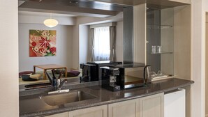 A modern kitchen with a built-in microwave, coffee maker, and a stainless steel sink. - HOTEL GLOBAL VIEW SAPPORO (Sapporo)