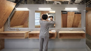 A bathroom with wooden vanity counters, a large mirror, and a tiled floor. - ℃ (Do-C) Gotanda (Tokyo)
